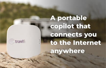 TravlFi Journey1 sitting on a rock in front of an RV with the caption "A portable copilot that connects you to the Internet anywhere"